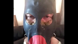 Gay rubber cadger wearing heavy rubber with the addition of spout bondage